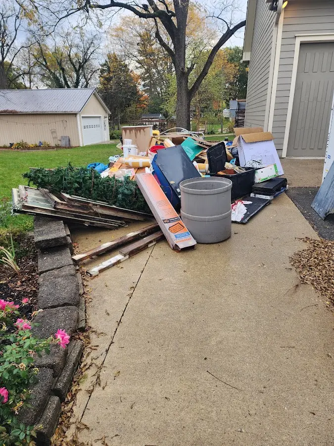 Dumpster being loaded with debris for 12 Yard Dumpster Rental in Eagle Lake